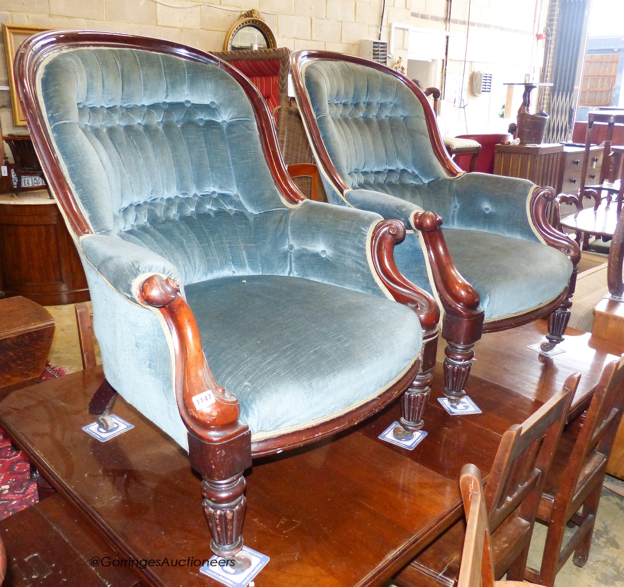 A pair of Victorian mahogany spoonback armchairs. W-71cm, D-84cm, H-95cm.